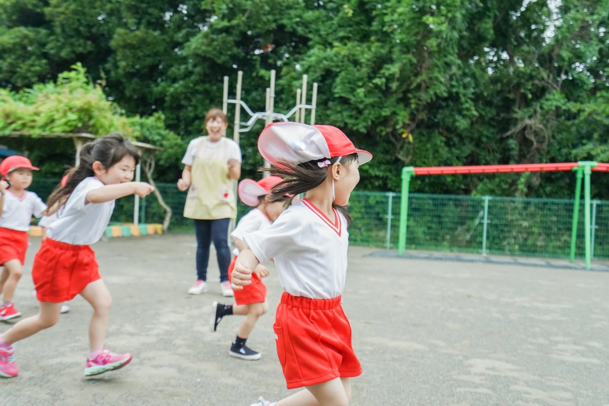 Children play outside at nursery school