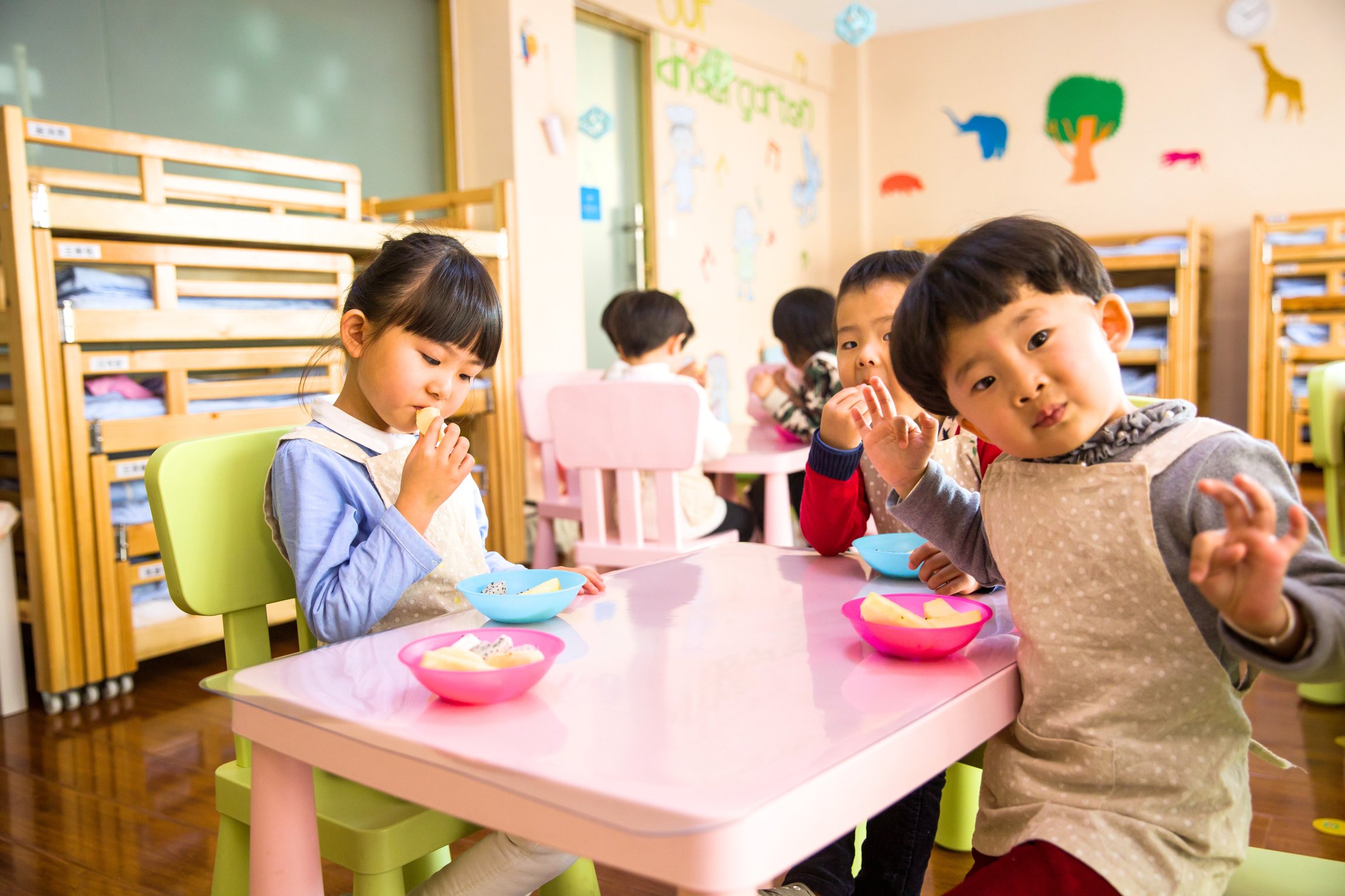 Three Toddler Eating on White Table